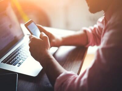 Man with laptop and phone