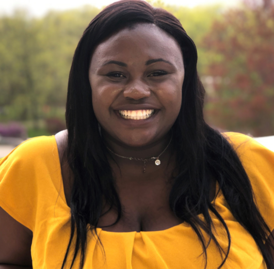 a black woman in a yellow shirt