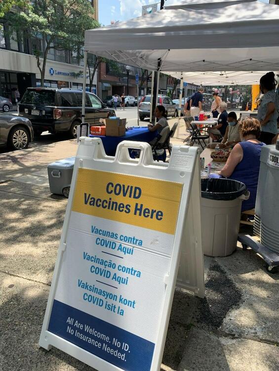 A street sign that says Covid vaccines here. Photos from a recent clinic held in partnership with Greater Lawrence Community Action Center.
