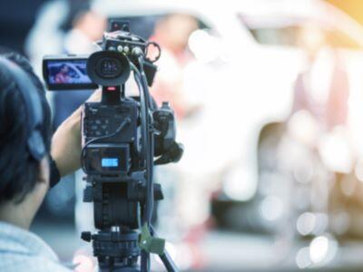 A news camera filming. 