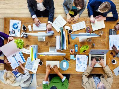 Colleagues gathered around a table meeting. 