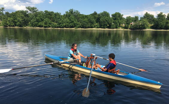 A sculler in a tandem shell sits forward in a FrontRower facing another sculler.