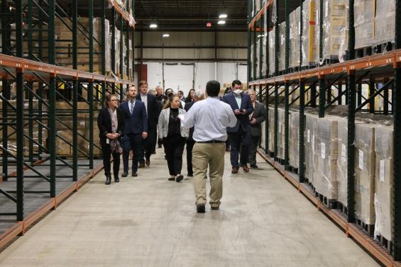 MEMA staff lead a group on a tour of the State Logistics Warehouse.