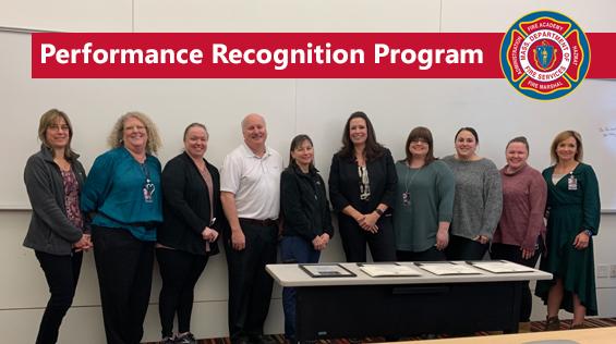 Photo of 10 staff members and the words "Performance Recognition Program"