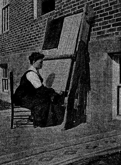 An employee who is blind weaving at an oriental loom