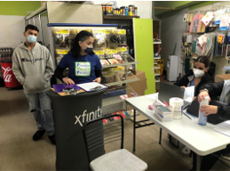 Four masked crew members preparing for the Covid-19 clinic at People's Supermarket.