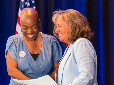 Two women veterans smiling