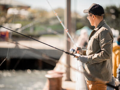 An angler fishing from a pier.