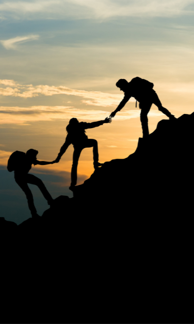 People helping eachother up a mountain