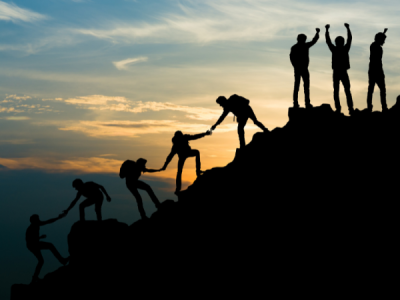 People helping eachother up a mountain