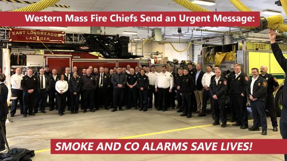 Photo of dozens of fire chiefs with the words "Smoke and CO alarms save lives"