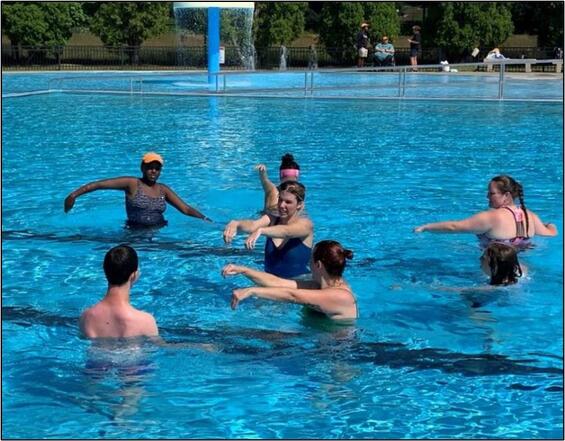 A group of people playing in a pool.