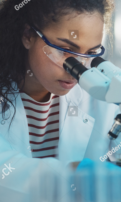 Person looking into a microscope