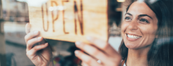 business owner with an open sign
