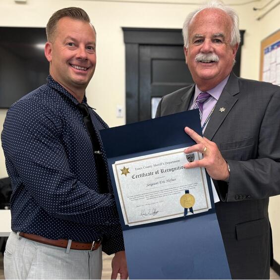 Sheriff Coppinger presents Sergeant Eric Hefner with a certificate