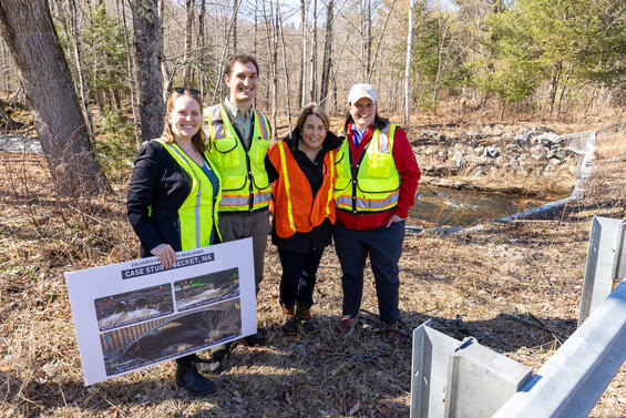 DER staff pose with Governor Healey next to a culvert.
