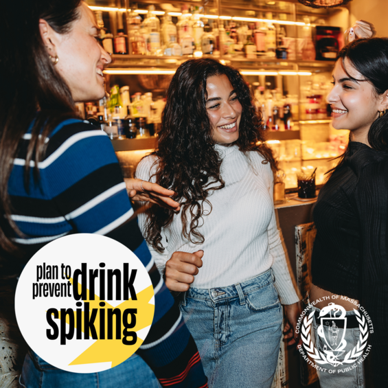 A group of young women drinking and chatting at a bar. The text reads "plan to prevent drink spiking".