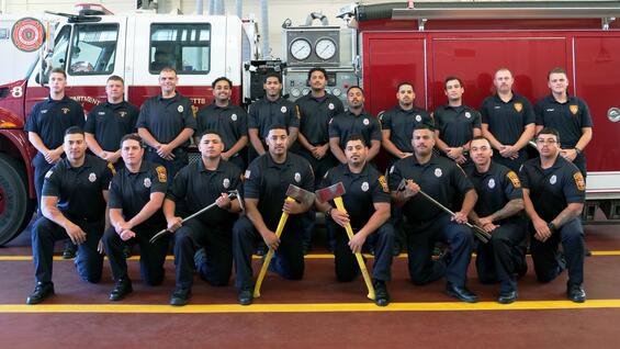 Firefighters in front of a ladder truck