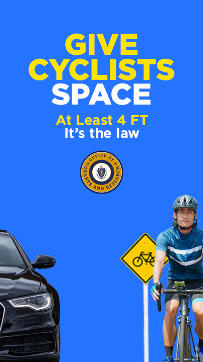 A car passes a bicyclist at a safe distance