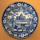 Ornate blue and white ceramic plate depicting a scene of the State House