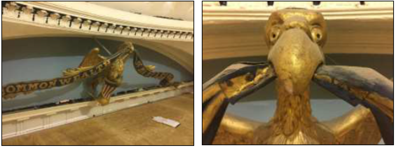 Gilded eagle gripping a Commonwealth banner in its beak