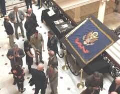 Members of the National Guard viewing the flag on display
