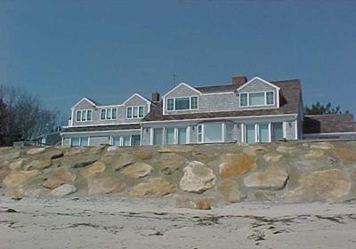 A sloping rock revetment with a smooth surface which will result in wave deflection and erosion.