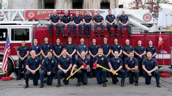 firefighters on and around a ladder truck
