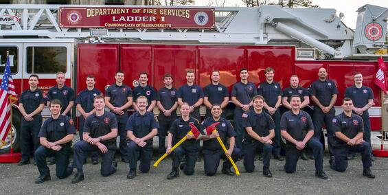 Firefighters on and around a ladder truck
