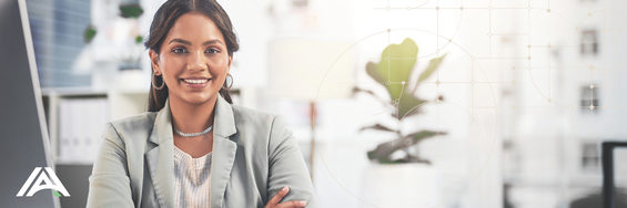 A person wearing a suit, smiling, arms folded. 