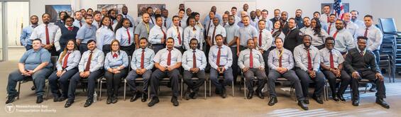 A class of new bus drivers celebrates their graduation from the MBTA training program