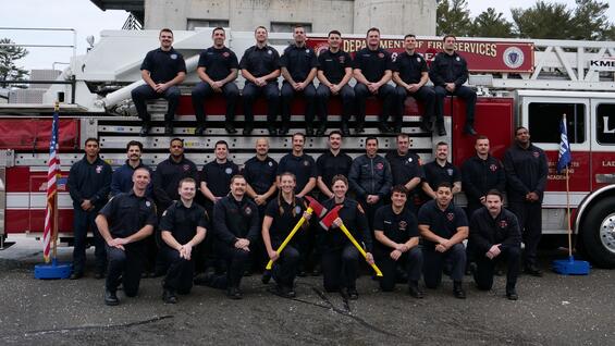 Firefighters on and around a ladder truck