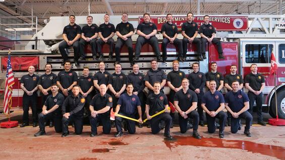 New firefighters on and around a ladder truck