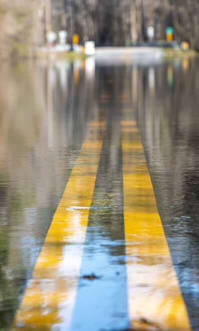 Never drive through flooded roads.