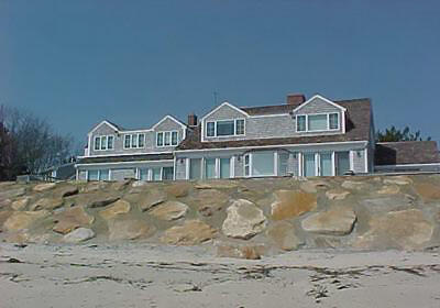 A sloping rock revetment with large rocks and the spaces in between filled with cement