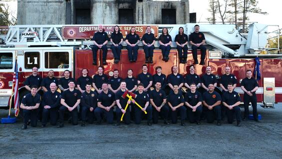 firefighters on and around a ladder truck