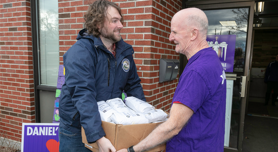 MassWildlife biologists hands over box of donated venison