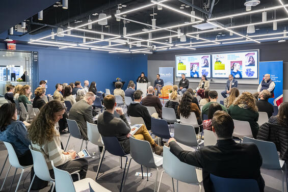 Conference room of people watching speakers