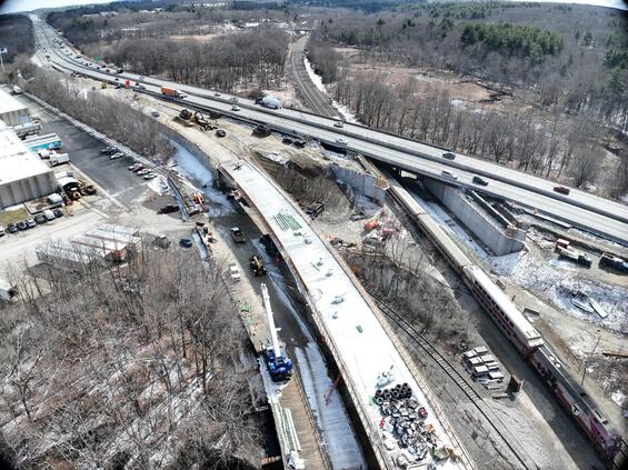 I-90 over the MBTA Commuter Rail Railroad and the ramp connecting I-90 westbound to I-495 northbound (looking southeast)