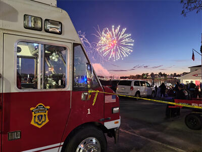 Fire apparatus with fireworks in the background