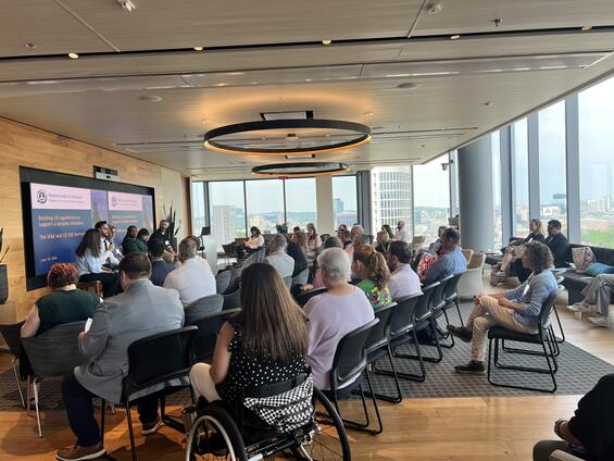 Attendees listening to a panel presentation.