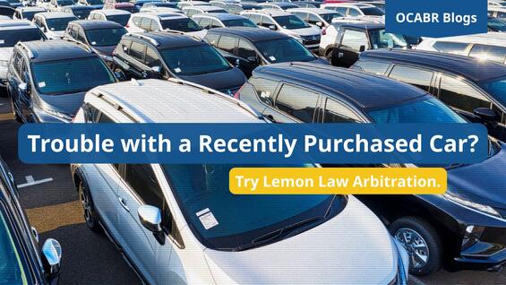 Dealership car lot, with a static effect. Blog title and subtitle are in white text on a blue and yellow box.