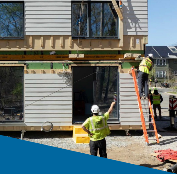 3 men working at a construction site building a home