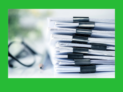 A stack of papers, clipped with a binder clip. 