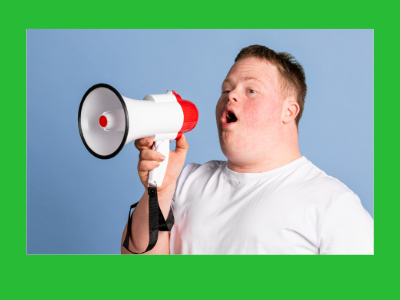 A person with down syndrome talking into a mega phone