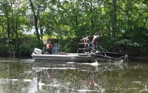 Researchers on a boat in a river.