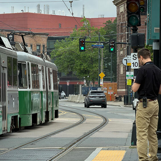 DPU watches a Green Line trolley pass by.