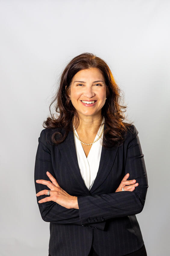 Headshot of Marisol Garcia smiling and crossing her arms