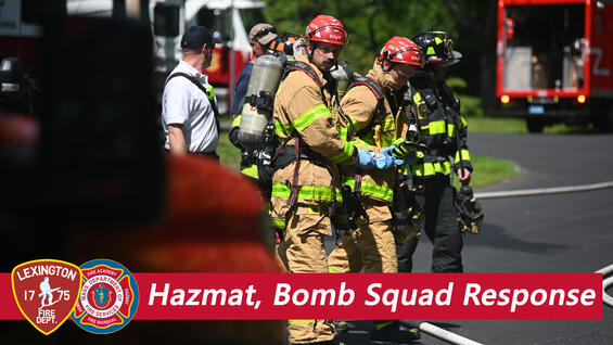 Hazmat technicians and firefighters on a street