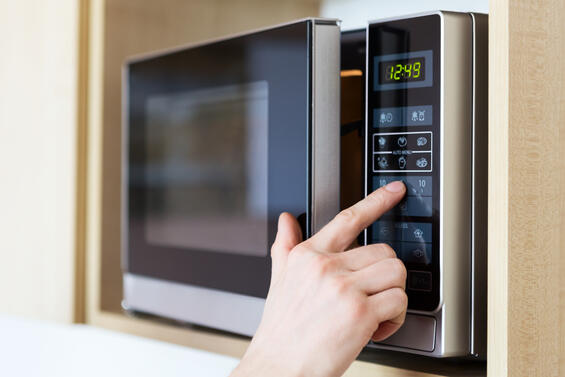 A person using a microwave